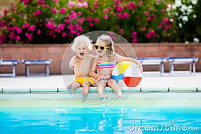 Kids playing at outdoor swimming pool Stock Photo