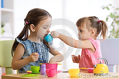 Kids playing with plastic tableware Stock Photo