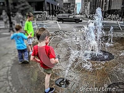 Kids playing in a public fountain in Louisville Kentucky Editorial Stock Photo