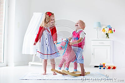 Kids playing with rocking horse Stock Photo