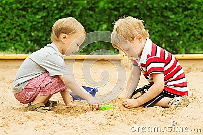 Kids Playing in Sand, Two Children Boys Outdoor Leisure in Sandbox Stock Photo