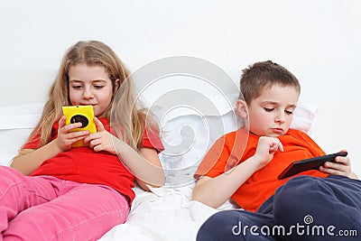 Kids playing with smartphone Stock Photo