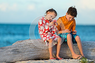 Kids playing on smartphone Stock Photo