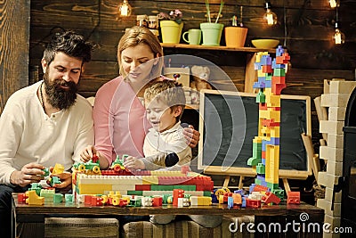 Kids playing with toys. Lovely family in playroom. Mom and kid playing with cars on race track out of plastic blocks Stock Photo