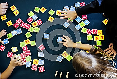 Kids playing wooden alphabets letters vocabulary ga Stock Photo