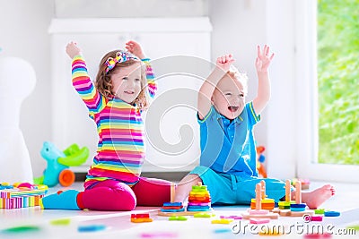 Kids playing with wooden blocks Stock Photo