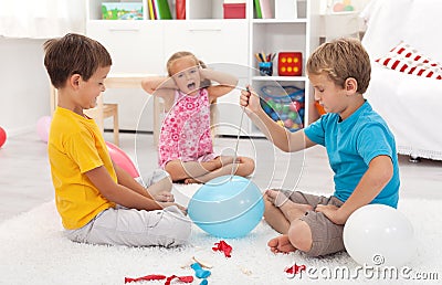 Kids popping balloons Stock Photo