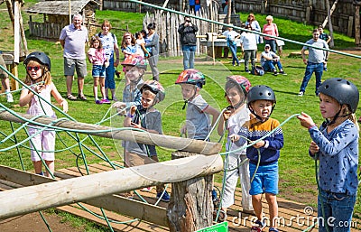 Kids practicing with the catapult in the Norman village. Reconstruction of medieval period 1050, educational centre for kids with Editorial Stock Photo
