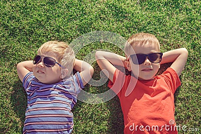 Kids relaxing on the grass Stock Photo