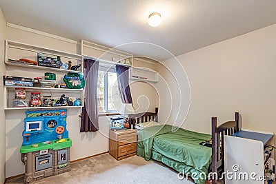 Kids room with toy kitchen shelves and toys children kids baby bed green white walls bright sunny Editorial Stock Photo