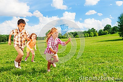 6 ,7 kids running with butterfly net Stock Photo