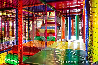 Kids running inside a Colorful indoor playground Stock Photo