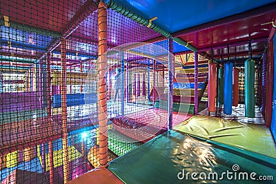 Kids running inside a Colorful indoor playground Stock Photo