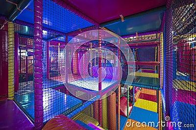 Kids running inside a Colorful indoor playground Stock Photo