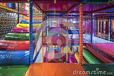 Kids running inside a Colorful indoor playground Stock Photo