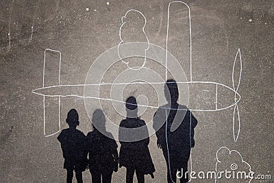 Kids shadows over a chalk plane Stock Photo
