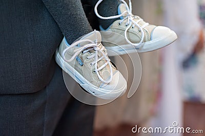 Kids Shoes and Man with Gray Suit in Background Editorial Stock Photo