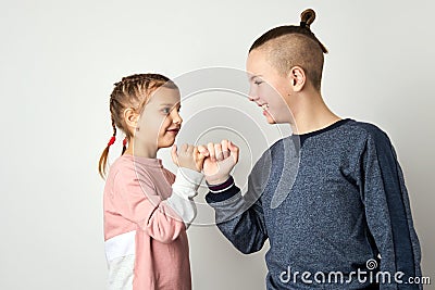 Kids show friendship and forgiveness, white background Stock Photo