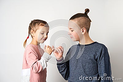 Kids show friendship and forgiveness, white background Stock Photo