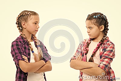 Kids sisters looks strictly. Girls folded arms on chest looks serious white background. Stubborn temper. Stubborn Stock Photo