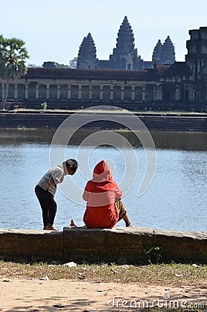 Kids sitting in front of Angkor Wat Cambodia ruin historic khmer temple Editorial Stock Photo