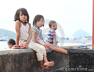 Kids sitting on railings in Labuan Bajo Editorial Stock Photo