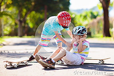 Kids with skate board. Skateboard fall and injury Stock Photo