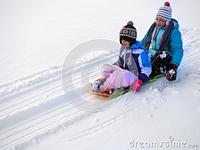 Kids Sledding Down Snow Hill on Sled Fast Speed Stock Photo