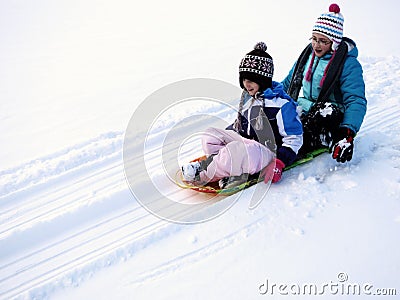 Kids Sledding Down Snow Hill on Sled Fast Speed Stock Photo