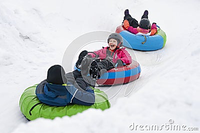 Kids Winter Snowtubing Stock Photo