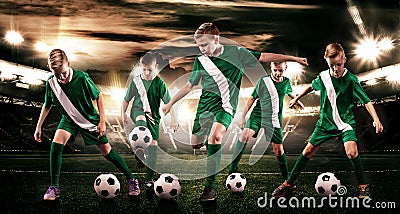 Kids - soccer champions. Boys in football sportswear on stadium with ball. Sport concept with soccer team. Stock Photo