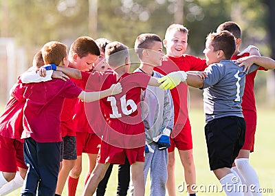 Kids soccer football - children players celebrating after victo Stock Photo