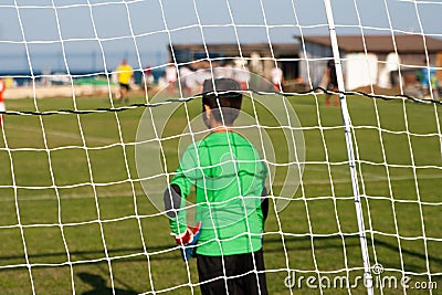 Kids soccer football - young children players match on soccer field near a sea Editorial Stock Photo