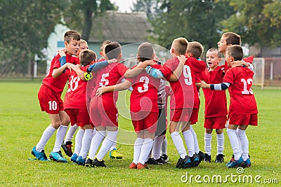 Kids soccer team in huddle Stock Photo