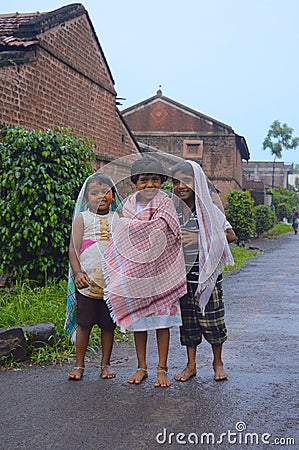 Kids standing and protecting themselves from rain Editorial Stock Photo