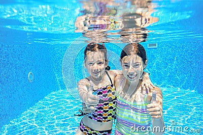 Kids swim in pool underwater Stock Photo