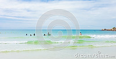 Kids Swimming on Fish Hoek beach on a cloudy day Editorial Stock Photo