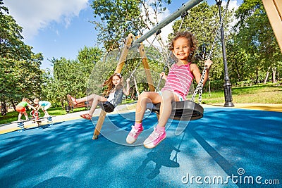 Kids swing on playground Stock Photo