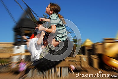 Kids on tire swing Stock Photo