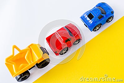 Kids toys cars on white and yellow background. Top view. Flat lay. for text Stock Photo