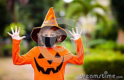 Kids trick or treat. Halloween in face mask Stock Photo