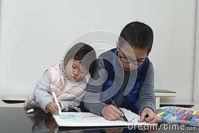 Kids using painting stick scrawl Stock Photo