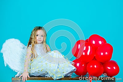 Kids Valentines Day. Wonderful blonde little girl in the image of an angel with white wings. Beautiful young girl Stock Photo