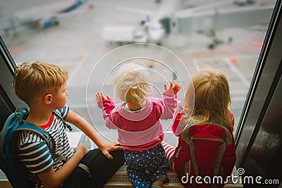 Kids waiting for plane in airport, family travel Stock Photo