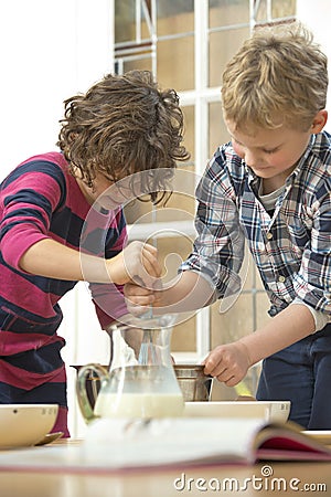 Kids whisking batter Stock Photo