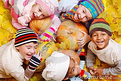 Kids on yellow leaves Stock Photo