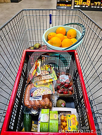 Kiel, Germany - 30 December 2023: View into a shopping cart in a German supermarket with many products Editorial Stock Photo