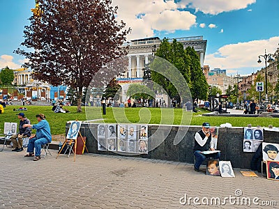 Street artists drawing portraits of tourists on canvas for money in independence square in Kiev Editorial Stock Photo