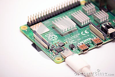 Kiev, Ukraine - August 13th, 2020: Connected to power supply by USB 3.0 type C cord SBC budget micro computer Raspberry Pi 4B. Editorial Stock Photo