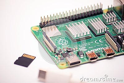 Kiev, Ukraine - August 13th, 2020: microsd card and usb type 3 cord with a single-board micro computer raspberry pi 4 on a white Editorial Stock Photo